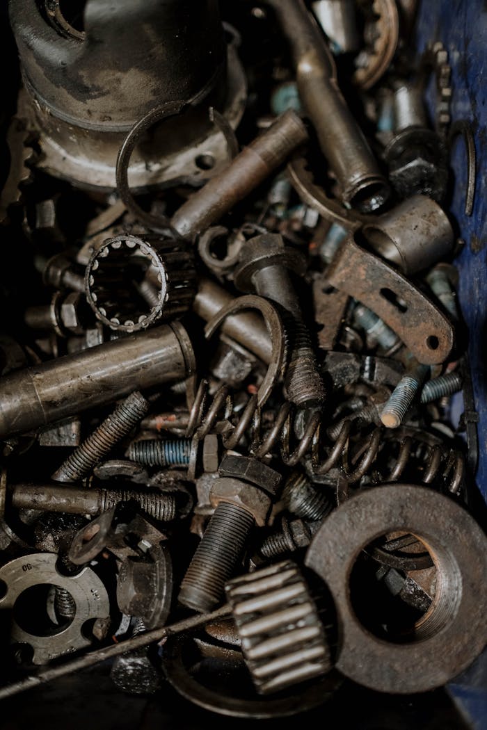 A detailed close-up of various metal gears and spare parts, perfect for industrial themes.